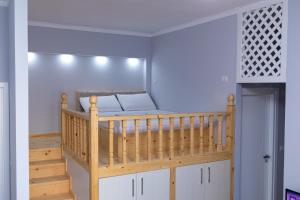 a bedroom with a bunk bed and a staircase at Villa ASET in Vlorë