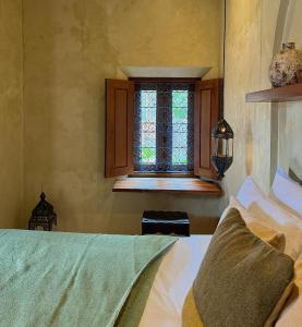 Schlafzimmer mit einem Bett und einem Fenster in der Unterkunft Lina Boutique Villas and Spa in Kuta Lombok