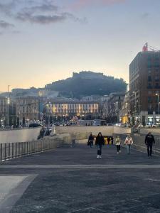 a group of people walking down a street in a city at B&B Ruffo Nel cuore di Napoli in Naples