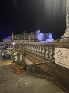 a building with potted plants on a bridge at night at B&B Ruffo Nel cuore di Napoli in Naples