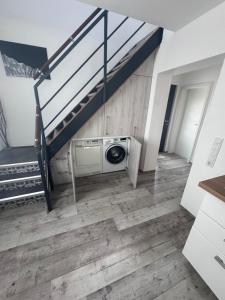 a room with a staircase and a washing machine at Casa Di Monaco in Glees