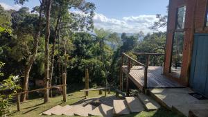 a porch of a house with a view of the forest at Refúgio na Mata - Casa de campo in Santo Antônio do Pinhal