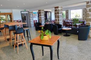 a restaurant with tables and chairs and a table at Hôtel du Golfe in Bonifacio