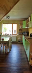 una cucina con armadi verdi e un tavolo di Sweet Home a Koknese