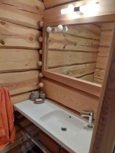 a bathroom with a sink and a mirror at Kuuse metsamaja in Saaremaa +20 photos