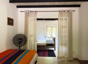 a bedroom with a bed and a window at Mind Body and Soul in Dambulla