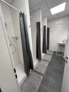 a bathroom with a row of showers and a sink at DRIVER ROOMS in Nuremberg