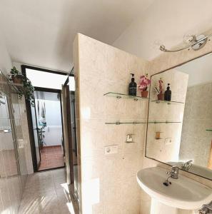 a bathroom with a sink and a shower and a mirror at CASA LORENZO in the center in Playa Blanca