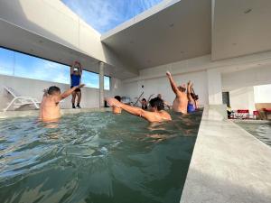 a group of people in a swimming pool at HOTEL & SPA JAMAX in Termas de Río Hondo