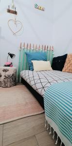 a bedroom with two beds and a table with a lamp at Maison de vacances 2 chambres plages lac à 600m proche Dune du Pilat Océan dans propriété privée in Sanguinet