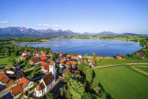an aerial view of a small town by a lake at Landhotelwohnung in Seeg in Seeg +3 photos