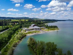 an aerial view of a resort on the shore of a lake at Landhotelwohnung in Seeg in Seeg