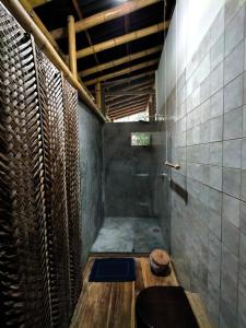 a bathroom with a shower with a toilet in it at Finca La Selvita in Buritaca