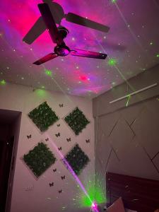 a ceiling with green and purple lights on a room at Bella Dreamy near expo mart greater Noida in Greater Noida
