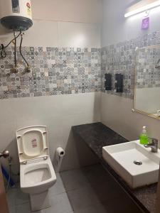 a bathroom with a toilet and a sink at Bella Dreamy near expo mart greater Noida in Greater Noida
