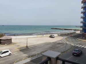 a parking lot next to the ocean with cars parked at Таня 11 in Pomorie