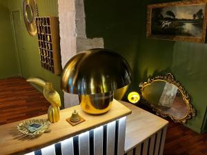 a table with a large metal helmet on top of it at Hôtel Abalone - Centre Gare in Nîmes