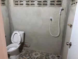 a small bathroom with a toilet and a shower at Baan sudjai homestay 