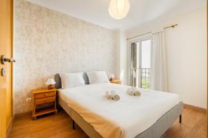 Ένα ή περισσότερα κρεβάτια σε δωμάτιο στο GuestReady - Sweet spot near Oceanário de Lisboa