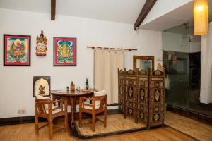 a dining room with a table and a table and chairs at Samsara Apartments by Baber Mahal Revisited in Kathmandu