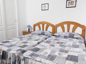 Łóżko lub łóżka w pokoju w obiekcie Apartamentos Topacio Unitursa
