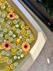 a tray of sliced oranges and lemons with flowers on it at Flowering Villa in Xiaoliuqiu