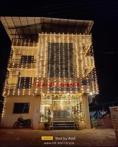 a building with lights on the front of it at Hotel Grand Ganesha in Ganpatipule