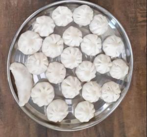 a bowl of dumplings on top of a table at Hotel Grand Ganesha in Ganpatipule
