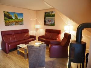 a living room with a couch and a wood stove at FEWO Seewind in Flessenow
