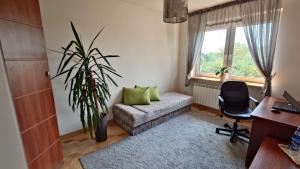 a living room with a couch and a chair at Pokoje u Agnieszki in Łuków