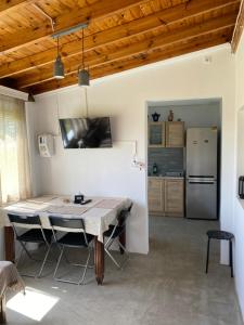 a kitchen and dining room with a table and a refrigerator at Pedi’s house in Aspropótamos