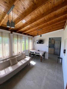 a living room with a couch and a table at Pedi’s house in Aspropótamos