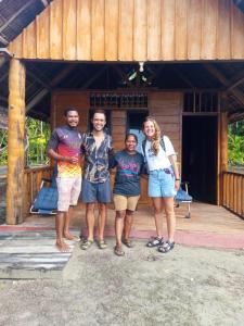 a group of people standing in front of a house at Famangkor Homestay in Yennanas Besir