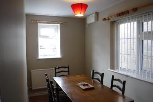 a dining room with a wooden table and chairs at Withern Mill Trout Farm in Great Carlton