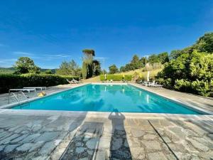 una piscina en una villa con jardín en Villa Badia a Ruoti, en Badia a Ruoti