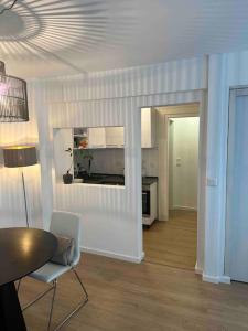 Appartement DUS في دوسلدورف: غرفة معيشة مع طاولة ومطبخ