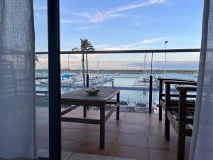 a balcony with a table and a view of a marina at Puerto Deportivo in Punta Umbría