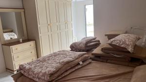a bedroom with two beds and a dresser and a closet at استراحة تل الشمال5 in Riyadh