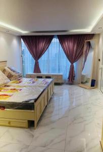 a bedroom with a large bed with purple curtains at استراحة تل الشمال5 in Riyadh