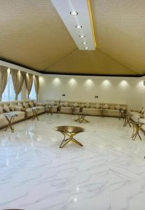 a large room with couches and a table on a marble floor at استراحة تل الشمال5 in Riyadh
