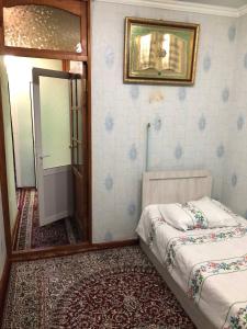 a bedroom with two beds and a mirror and a door at Korzinka in Fergana