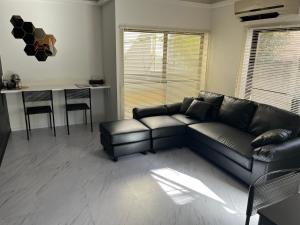 a living room with a black couch and a table at ATW Tokyo Near the station Close to Asakusa Airport For infants and toddlers in Tokyo