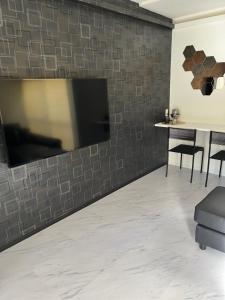 a living room with a tv on a brick wall at ATW Tokyo Near the station Close to Asakusa Airport For infants and toddlers in Tokyo +40 photos