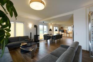 a living room with a couch and a table at Villa Meermaid mit Schwimmbad in Hohen Wieschendorf