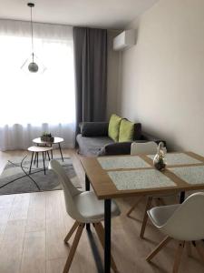 a living room with a table and chairs and a couch at *HOT* Main Square Brand New Luxury Apartment in Burgas City