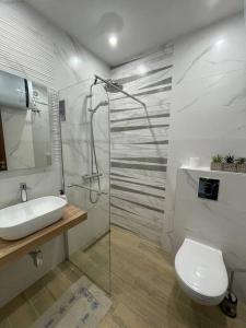 a bathroom with a toilet and a sink and a shower at *HOT* Main Square Brand New Luxury Apartment in Burgas City