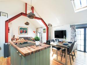 a kitchen and living room with a table and chairs at The Old Stables in Totnes