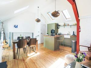 a kitchen and dining room with a table and chairs at The Old Stables in Totnes