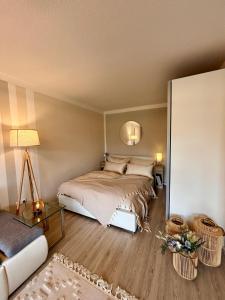 a bedroom with a bed and a living room at Stylish studio apartment with terrace in Ingolstadt