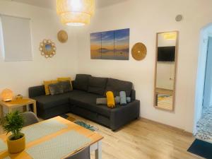 a living room with a couch and a table at BDCSNY Apartman in Badacsonytördemic